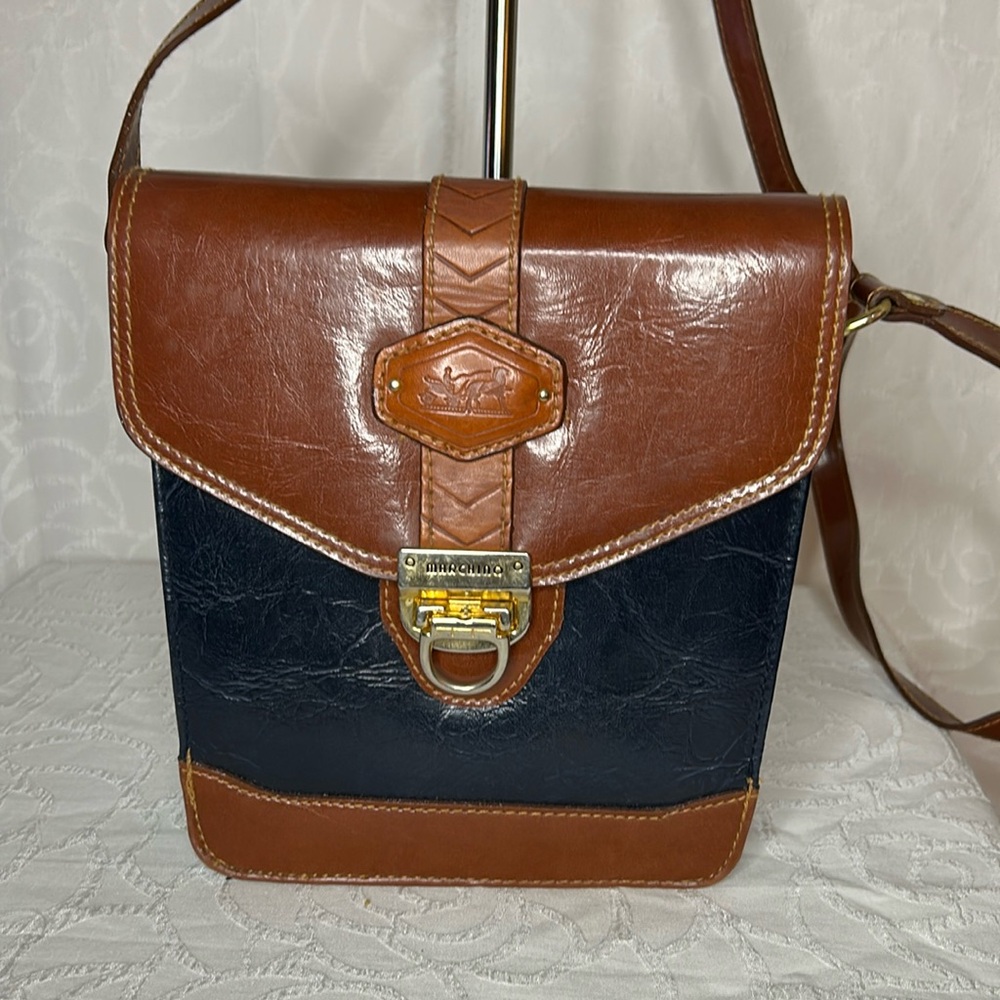 MARCHINO brown, black, and gold leather bucket style handbag. Gold hardware.